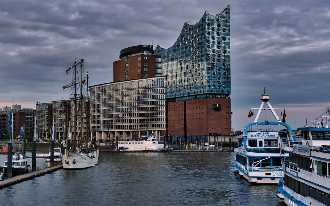 Elbphilharmonie mit Booten im Hamburger Hafen bei Dämmerung