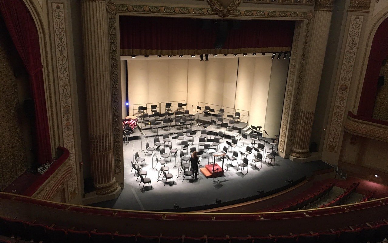 Symbolbild Theater: Blick vom Rang auf eine Bühne mit Orchester